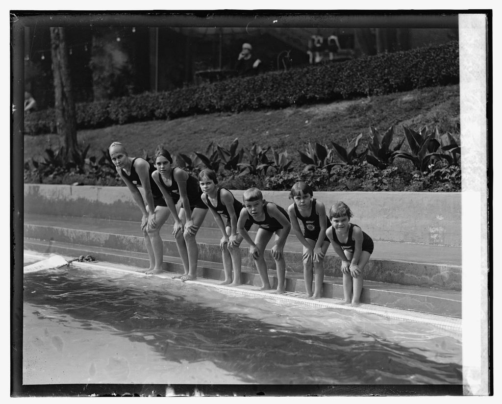 The outdoor swimming pool with loungers alongside