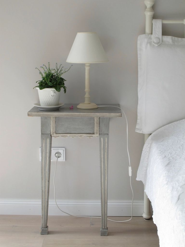 A guest room with a large bed and soft lighting