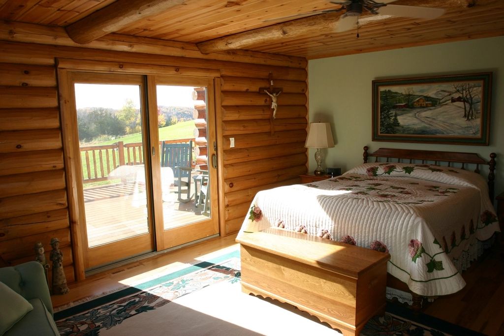 A guest room with two beds and a window